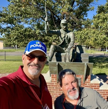 Friends beside a statue on the grounds — photo 26